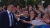 En route to his presidential inauguration in Ukraine's Verkhovna Rada, Volodymyr Zelenskiy poses for a selfie with a fan. 
