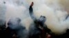 Ukrainian activists throw smoke flares during an October 30, 2020 rally outside Kyiv's Constitutional Court building. The demonstrators demanded that the judges come out and explain their reasons for ruling against criminal penalties for false financial disclosures by officials. 