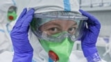 A medical specialist puts on personal protective equipment in Moscow's RZD-Medicine Central Clinical Hospital, which treats coronavirus patients. 